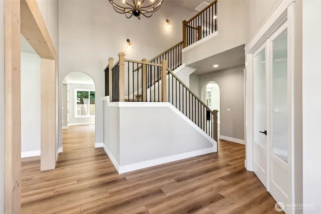 a view of a hallway view with wooden floor and staircase