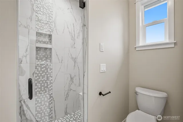 a white toilet sitting next to a bathroom sink