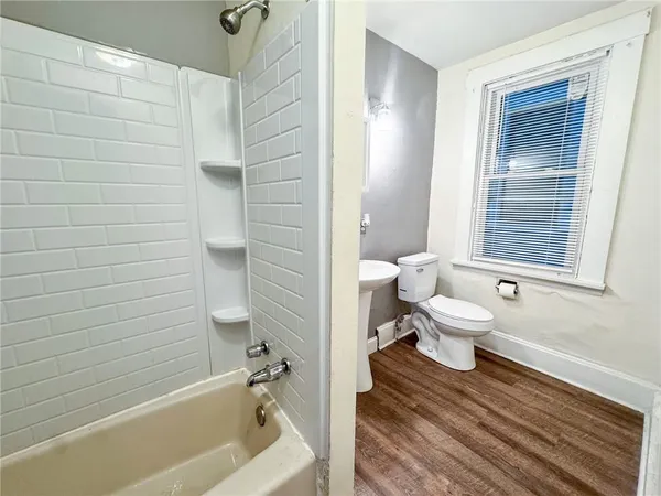 a bathroom with a toilet and a shower