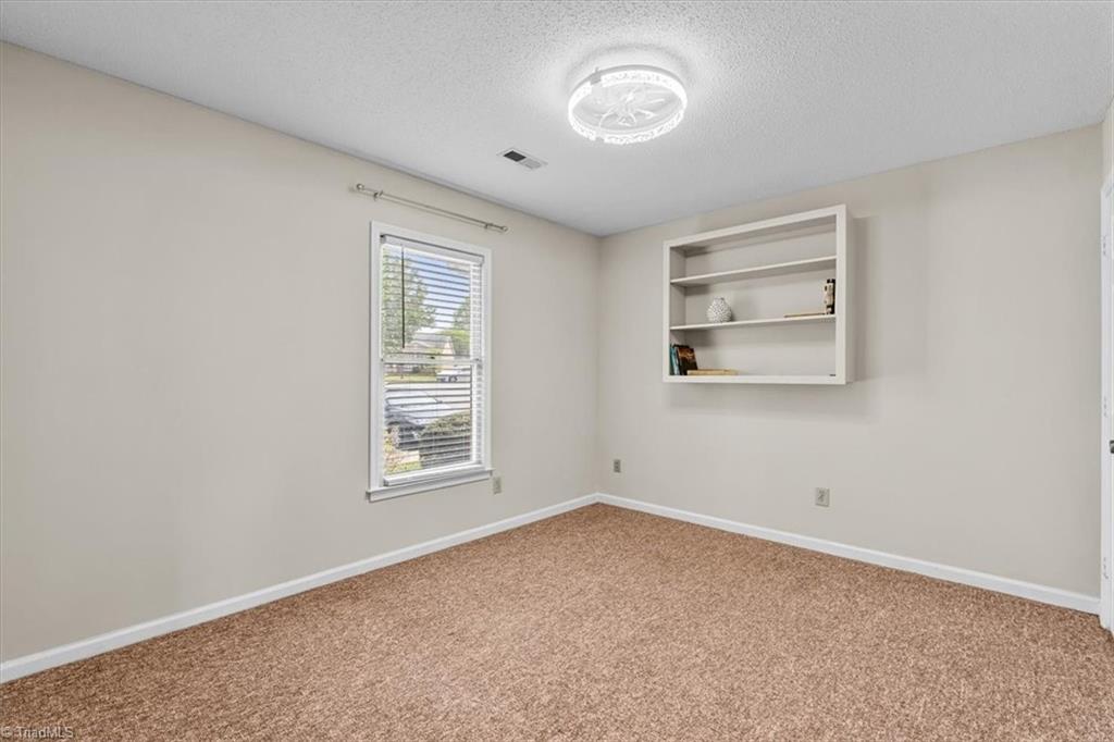 814 Guilford College Road, Unit 133 Greensboro, NC 27409 - Photo 11 of 18 Bedroom 2 with built-in shelving
