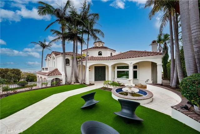a view of a house with backyard sitting area and swimming pool