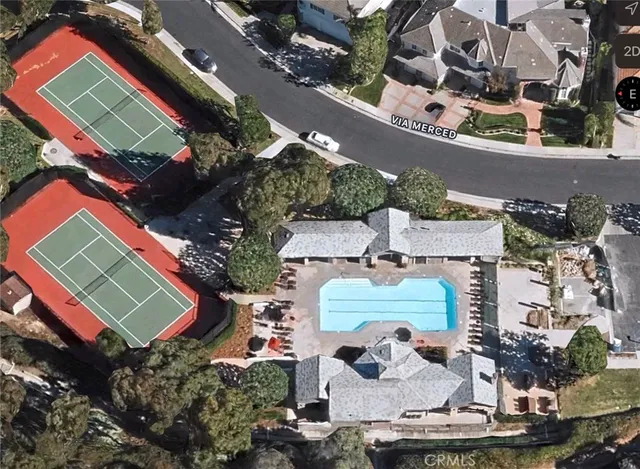an aerial view of a house with a swimming pool patio and outdoor seating
