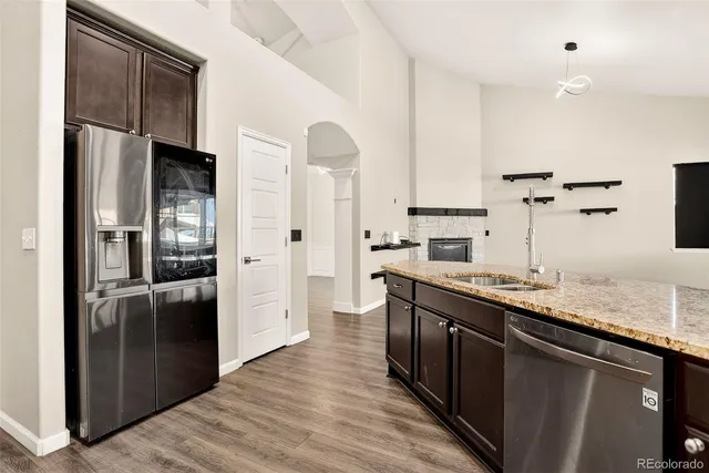 a kitchen with stainless steel appliances granite countertop a refrigerator and a sink
