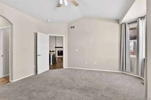 a view of a big room with wooden floor and a bathroom