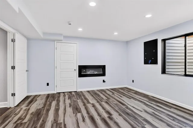 a view of a room with wooden floor and window