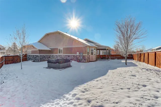 a view of a house with backyard and covered with snow