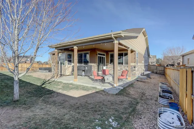 a view of a white house with a big yard and large trees