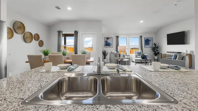 a kitchen with stainless steel appliances granite countertop a stove and a sink