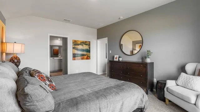 a bedroom with a bed and a tv on dresser