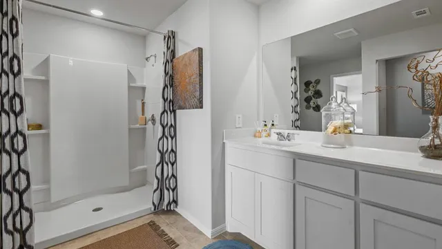a en suite bathroom with a sink a mirror and a