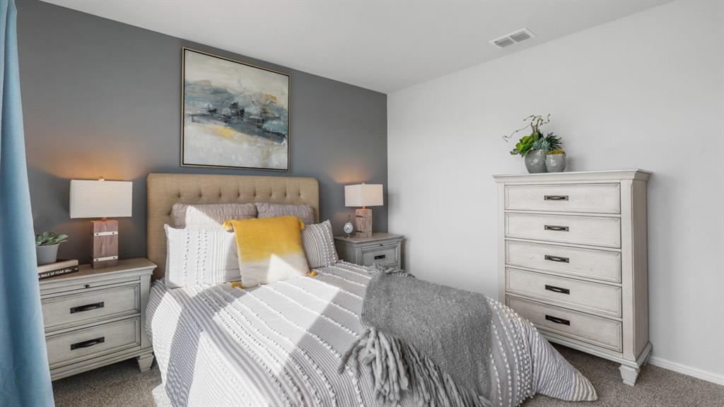 320 Blanco Drive Azle, TX 76020 - Photo 28 of 40 a bedroom with a bed and a lamp on dresser