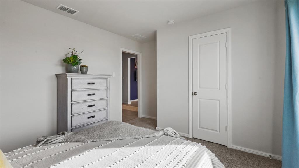 320 Blanco Drive Azle, TX 76020 - Photo 29 of 40 a bedroom with a bed and a dresser