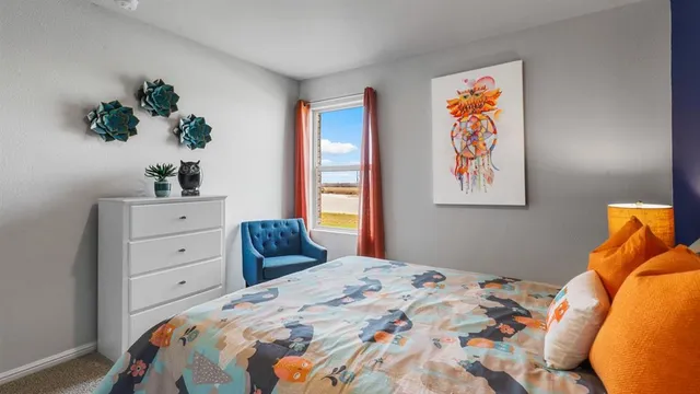 a bedroom with a bed and a painting on the wall