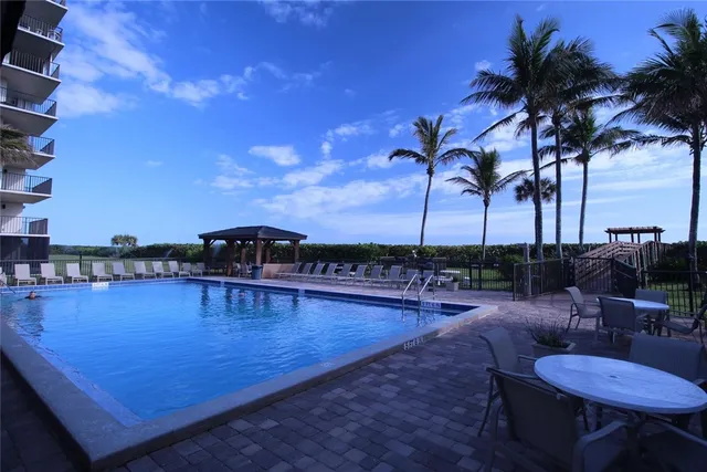 a view of a swimming pool with a table and chairs