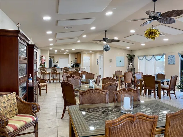a living room with lots of furniture and a dining table with wooden floor