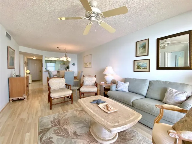 a living room with furniture a rug and a chandelier