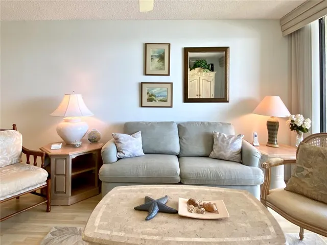 a living room with furniture a lamp and a window