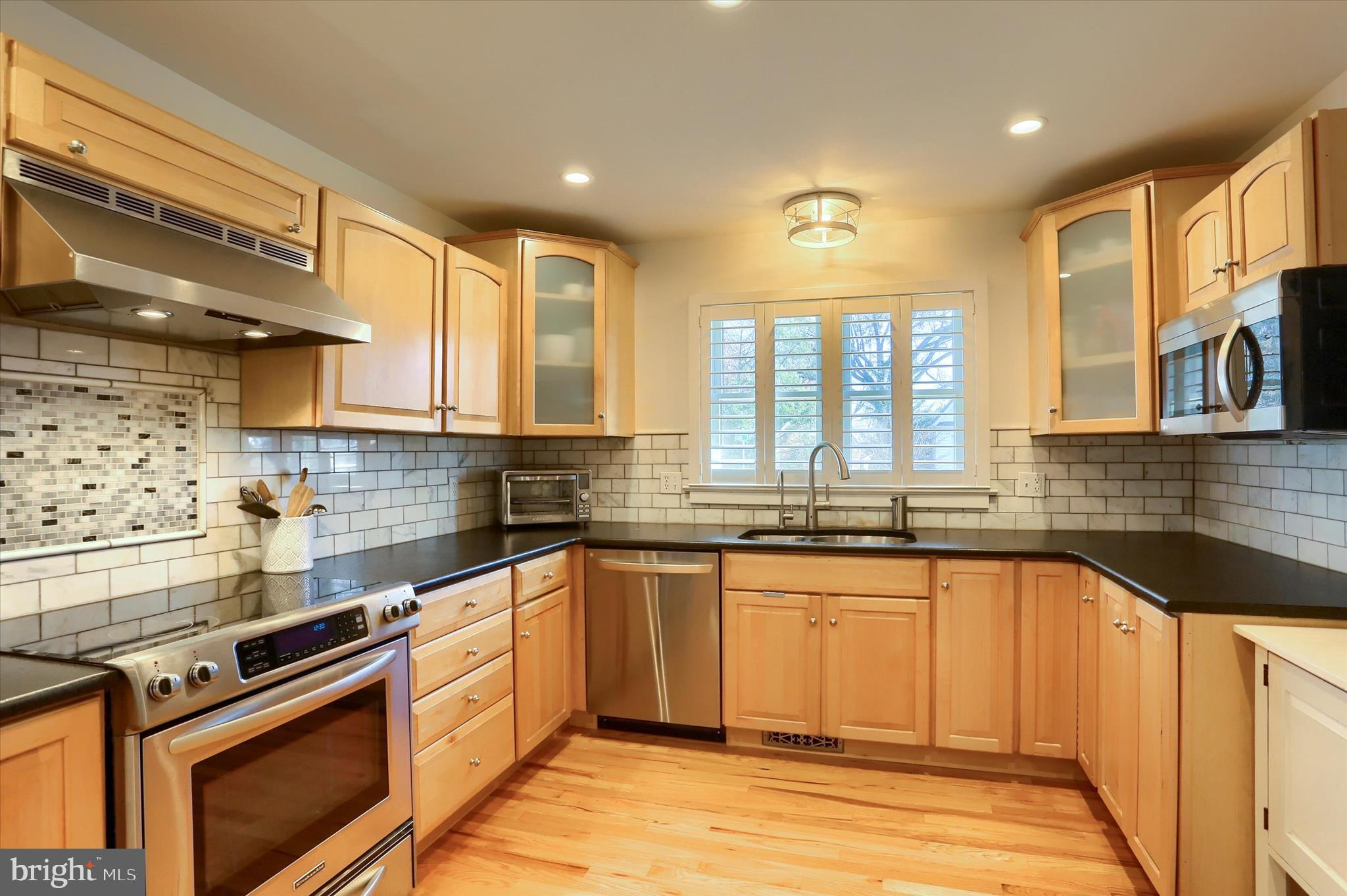 155 Oak Lane Hershey, PA 17033 - Photo 17 of 54 a kitchen with stainless steel appliances granite countertop a stove a sink and a granite counter tops with wooden cabinets