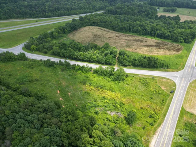 a view of a green field with a lake