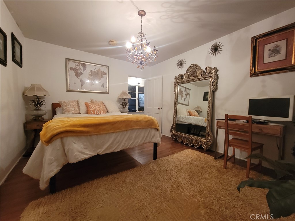 4600 9th Street Riverside, CA 92501 - Photo 13 of 21 a bedroom with a bed and a chandelier