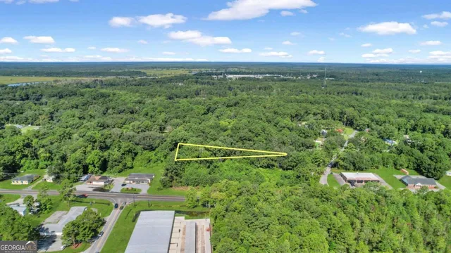a view of a green yard with a house in the background