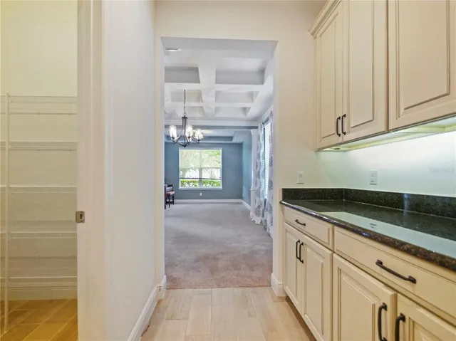 a kitchen with granite countertop white cabinets and sink