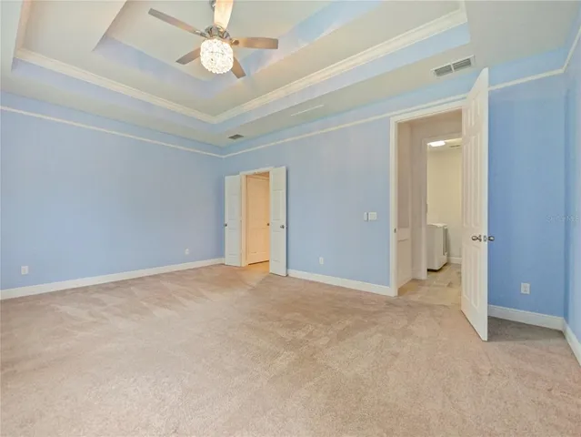 an empty room with fan and entrance