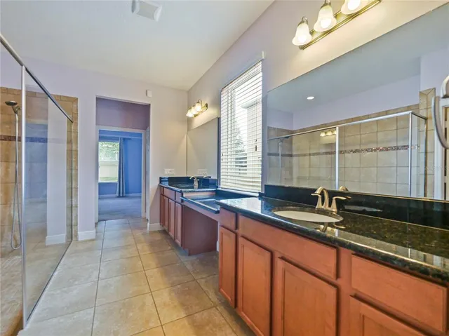 a kitchen with a sink and large mirror