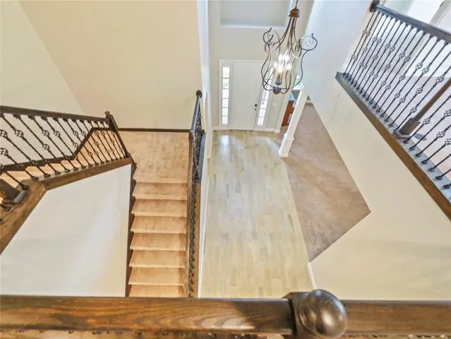 a view of staircase with white floor and fan