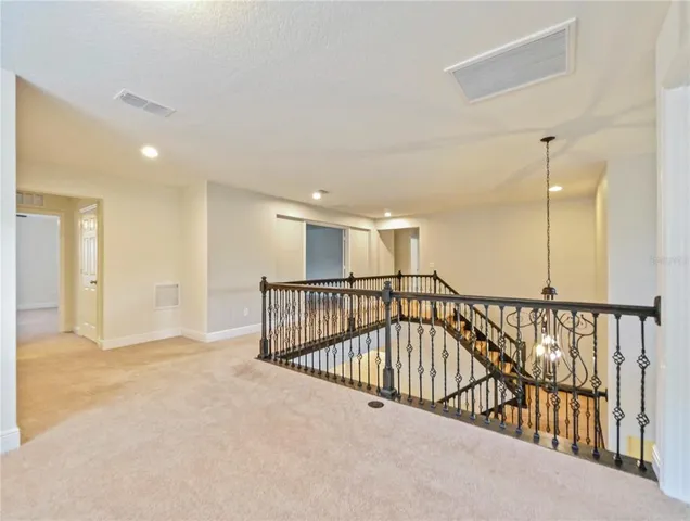 a view of an empty room with a floor to ceiling window and an outdoor view