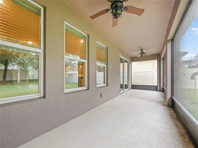 a view of a yard in front of a house with large tree