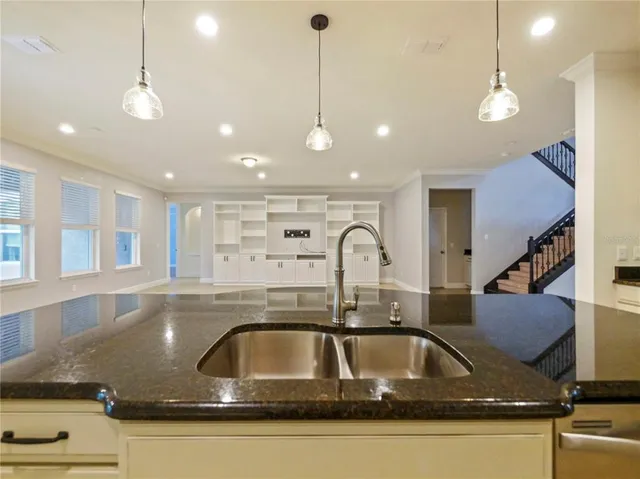 a kitchen with a sink a counter space and cabinets