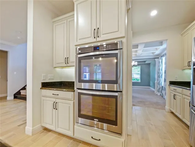 a kitchen with granite countertop a stove and a sink