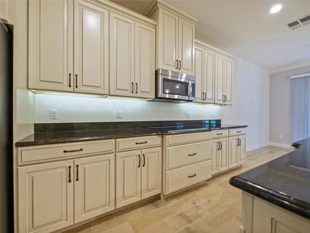a kitchen with white cabinets and white appliances