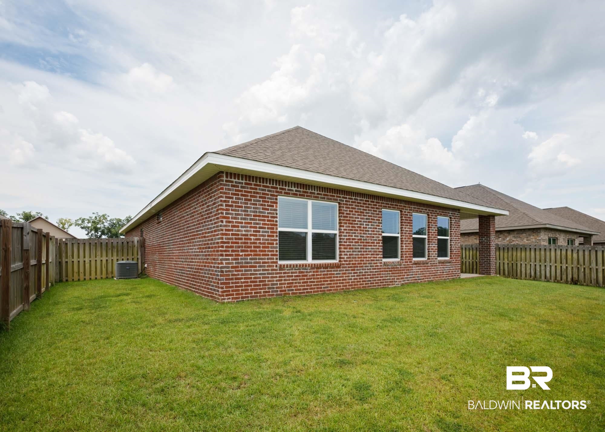 1436 Kairos Loop Foley, AL 36535 - Photo 4 of 52 Back of property with a fenced backyard, brick siding, and a shingled roof