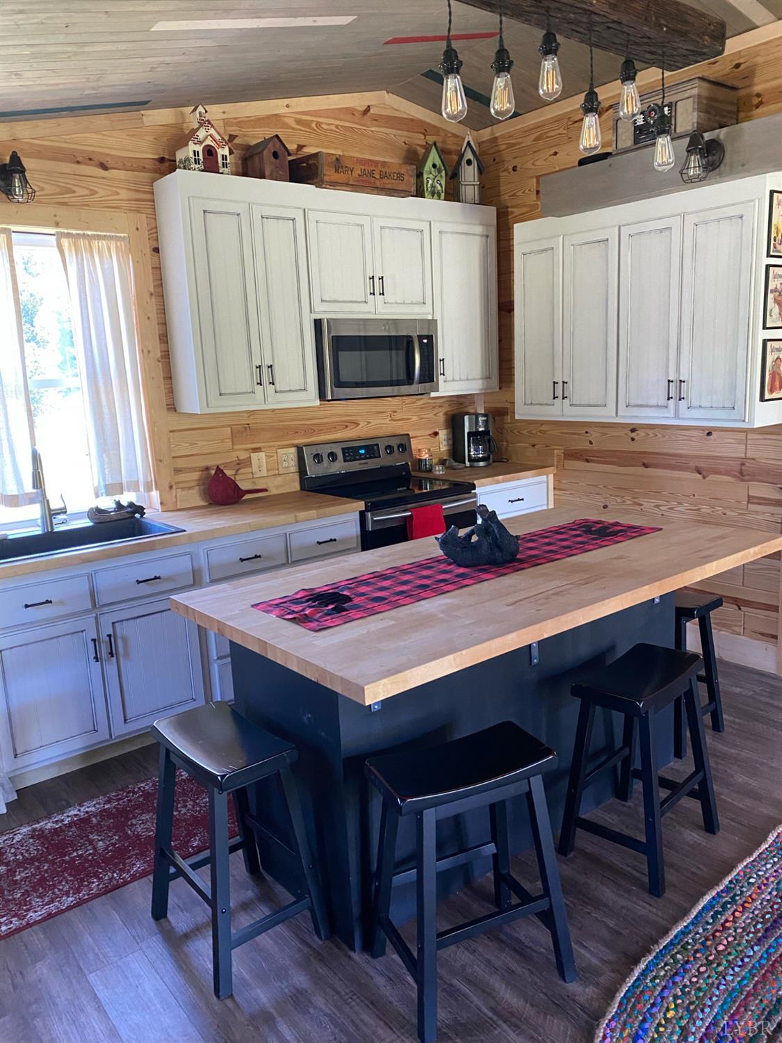 7392 Peaks Road Bedford, VA 24523 - Photo 16 of 48 a kitchen with a table chairs and a refrigerator