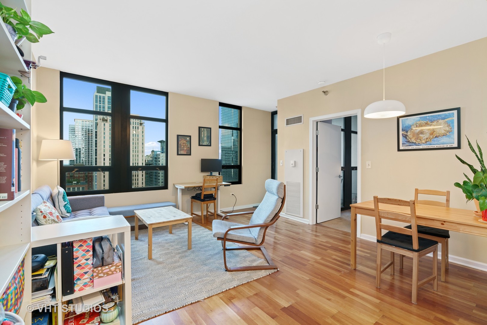 1255 South State Street, Unit 1809 Chicago, IL 60605 - Photo 2 of 11 a living room with furniture and a book shelf