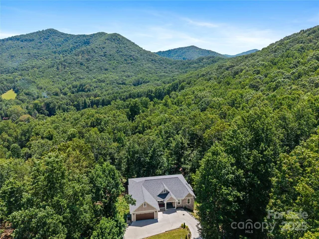 an aerial view of a house with mountain view
