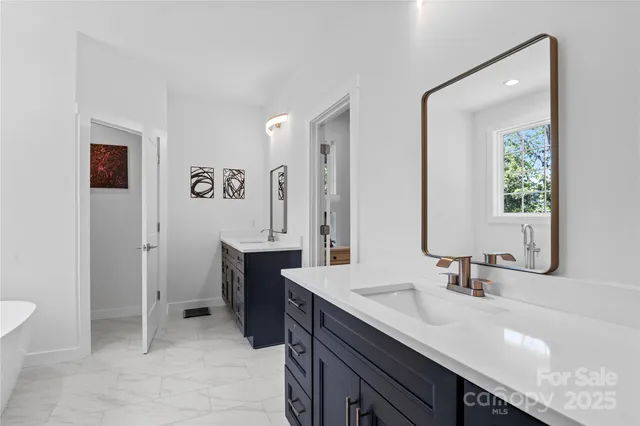 a spacious bathroom with a granite countertop sink and a mirror
