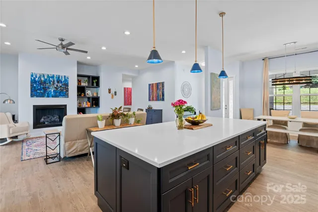 a living room with furniture a fireplace and a chandelier