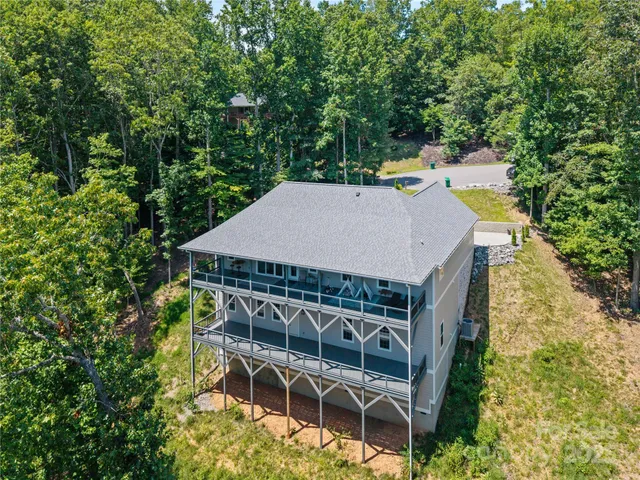 a roof deck with table and chairs and potted plants