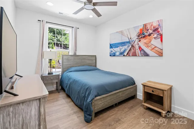 a bedroom with a bed and a painting on the wall