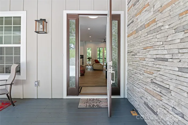 a view of a hallway with wooden floor and bedroom