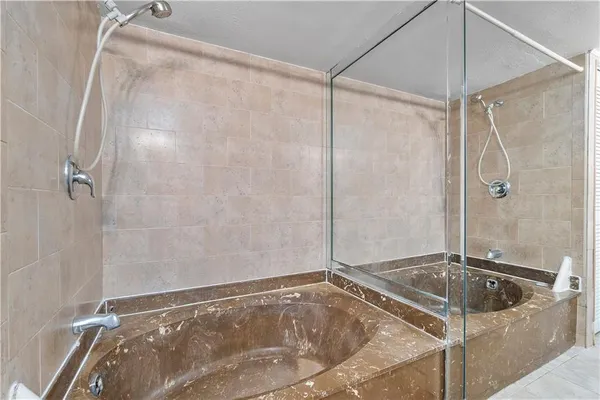 a bathroom with a tub and a shower