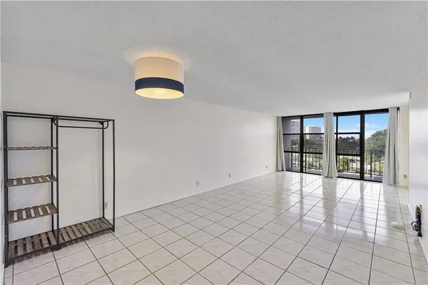 an empty room with entrance and windows