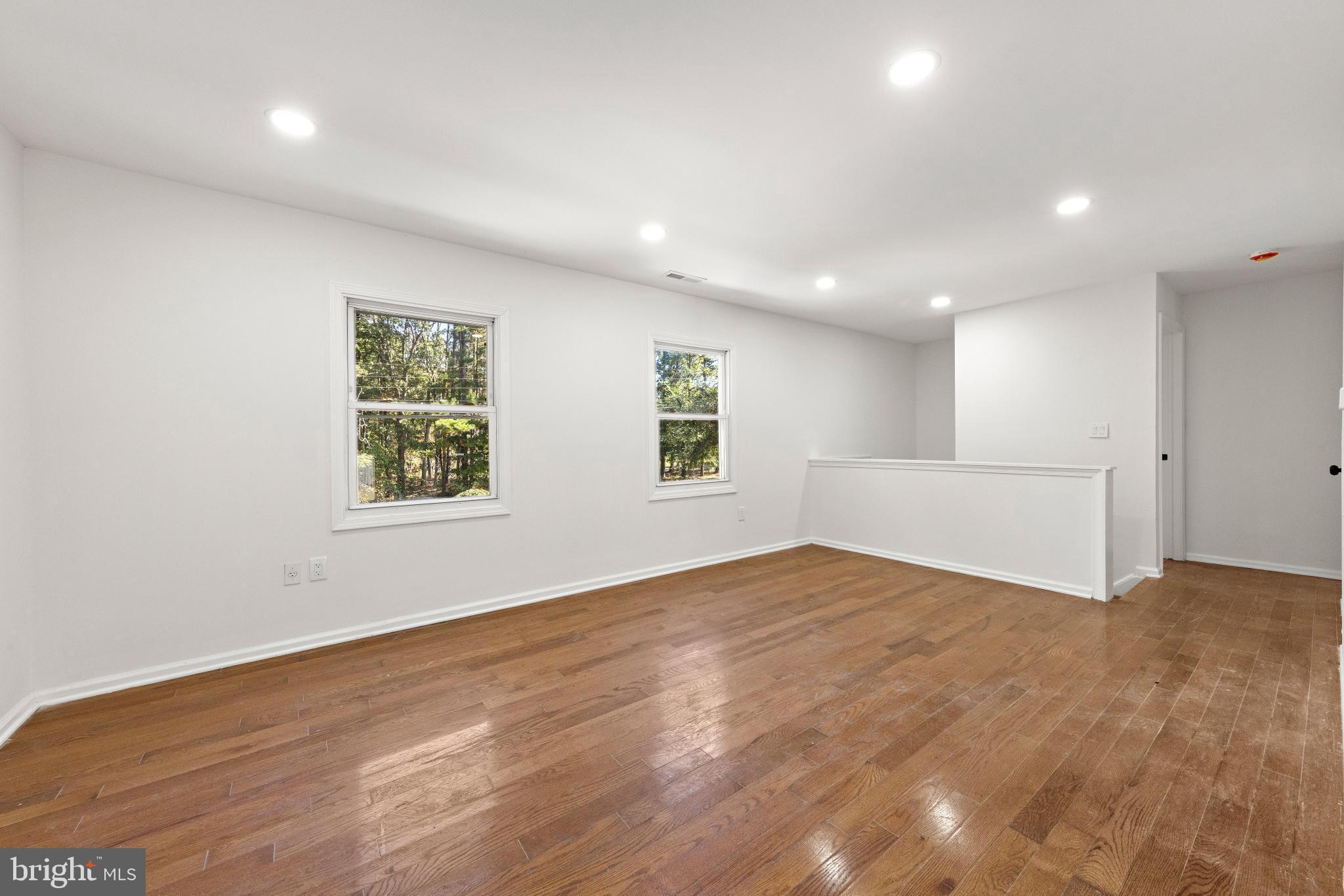 716 6th Road Newtonville, NJ 08346 - Photo 8 of 43 an empty room with wooden floor and windows
