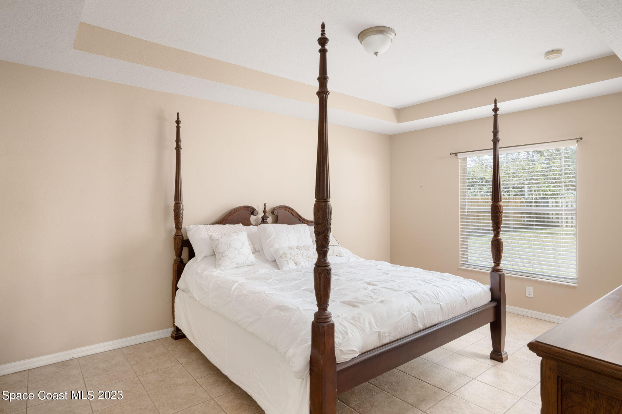 167 Spring Valley Avenue Sebastian, FL 32958 - Photo 18 of 34 a large bed sitting in a bedroom next to a window