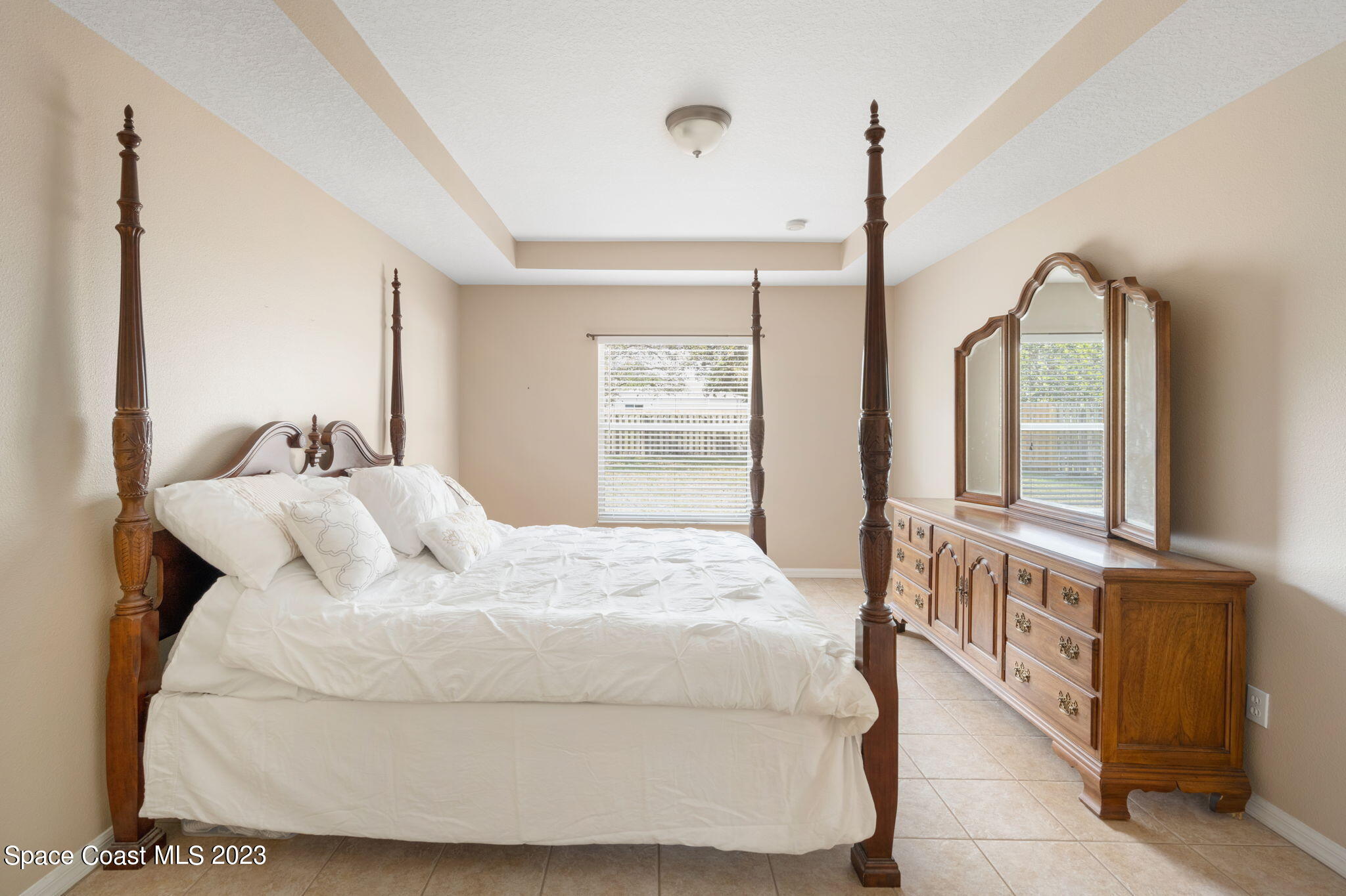 167 Spring Valley Avenue Sebastian, FL 32958 - Photo 19 of 34 a bed sitting in a bedroom next to a window