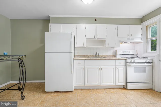 a white refrigerator freezer sitting in a kitchen