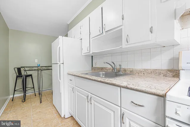 a kitchen with sink cabinets and appliances